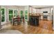 Charming breakfast nook alongside the kitchen featuring stainless appliances and a unique stone breakfast bar at 963 Hawk Creek Trl, Lawrenceville, GA 30043