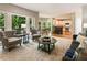 Open-concept living area with access to the kitchen and a view of the outdoor deck and green landscape at 963 Hawk Creek Trl, Lawrenceville, GA 30043