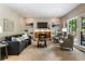 Cozy living room featuring a stone fireplace, built-in shelving, comfortable sofa, and a sliding glass door at 963 Hawk Creek Trl, Lawrenceville, GA 30043