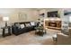 Cozy living room with a stone fireplace, built-in shelves, and comfortable seating arrangements at 963 Hawk Creek Trl, Lawrenceville, GA 30043
