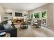 Bright living room features a stone fireplace, built-in shelves, and large windows with wooded views at 963 Hawk Creek Trl, Lawrenceville, GA 30043