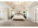 Spacious main bedroom with vaulted ceiling, neutral color palette and sitting area at 963 Hawk Creek Trl, Lawrenceville, GA 30043
