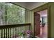 View of balcony with wooded view and freshly painted door leading to living room at 1015 Dunbar Dr, Dunwoody, GA 30338