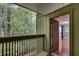 View of balcony with wooded view and freshly painted door leading to living room at 1015 Dunbar Dr, Dunwoody, GA 30338