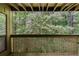 Balcony with wooden railing overlooking lush, green trees at 1015 Dunbar Dr, Dunwoody, GA 30338