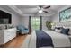 Comfortable bedroom featuring a ceiling fan, gray walls, and a sliding glass door to the exterior at 1015 Dunbar Dr, Dunwoody, GA 30338