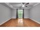 Spacious bedroom featuring hardwood floors, a ceiling fan, and a sliding glass door to the exterior at 1015 Dunbar Dr, Dunwoody, GA 30338