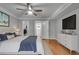 Bedroom with hardwood floors, large bed with blue accents, and a closet that leads to the bathroom at 1015 Dunbar Dr, Dunwoody, GA 30338