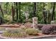 Stone sign at the entrance to Dunwoody Court community with lush landscaping at 1015 Dunbar Dr, Dunwoody, GA 30338