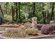 Dunwoody Court entrance sign with beautiful landscaping and stone pillar at 1015 Dunbar Dr, Dunwoody, GA 30338