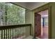 Inviting entryway features a wood door, hardwood floors, and a beautiful view of the surrounding greenery at 1015 Dunbar Dr, Dunwoody, GA 30338