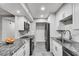 Modern kitchen featuring granite countertops, stainless steel appliances, and white cabinets at 1015 Dunbar Dr, Dunwoody, GA 30338