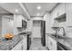 Modern kitchen featuring granite countertops, white cabinets and stainless steel appliances at 1015 Dunbar Dr, Dunwoody, GA 30338