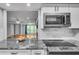 Open kitchen with granite countertops and modern microwave at 1015 Dunbar Dr, Dunwoody, GA 30338
