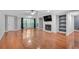 Spacious living room featuring hardwood floors, fireplace and view to trees outside at 1015 Dunbar Dr, Dunwoody, GA 30338
