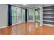 View of a room with a hardwood floor and windows with blue curtains and view to balcony at 1015 Dunbar Dr, Dunwoody, GA 30338