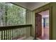 Bright living room with hardwood floors, a fireplace with built-in shelving, and a view to the porch at 1015 Dunbar Dr, Dunwoody, GA 30338