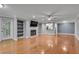 Bright living room with hardwood floors, fireplace, and open view to kitchen at 1015 Dunbar Dr, Dunwoody, GA 30338