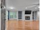 Bright living room features a fireplace, built-in shelves, wood floors, and sliding glass doors at 1015 Dunbar Dr, Dunwoody, GA 30338