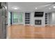 Open-concept living room featuring hardwood floors, fireplace and built in bookshelves at 1015 Dunbar Dr, Dunwoody, GA 30338