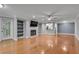 Inviting living room boasts a fireplace, built-in shelves, hardwood floors, and seamless access to kitchen at 1015 Dunbar Dr, Dunwoody, GA 30338