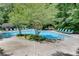 Community pool with lounge chairs and grill amidst lush greenery at 1015 Dunbar Dr, Dunwoody, GA 30338