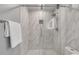 Modern shower with glass doors, marble-style tiling, and silver fixtures at 1015 Dunbar Dr, Dunwoody, GA 30338