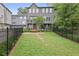 Large backyard featuring green grass, black fence, and bench for relaxing at 3 Becker Nw Pl, Atlanta, GA 30307