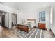 Cozy bedroom with hardwood floors, a full-sized bed, and ample lighting at 3 Becker Nw Pl, Atlanta, GA 30307
