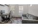 Cozy bedroom features hardwood floors, comfortable sofa, and desk with computer at 3 Becker Nw Pl, Atlanta, GA 30307