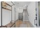 Bright entryway featuring wood floors, coat rack, and staircase leading to the second level at 3 Becker Nw Pl, Atlanta, GA 30307
