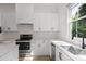 Modern kitchen with stainless steel appliances, undermount sink, and bright white cabinetry at 3 Becker Nw Pl, Atlanta, GA 30307