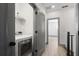 Laundry room features white washer and dryer and leads into hallway with hardwood flooring at 3 Becker Nw Pl, Atlanta, GA 30307
