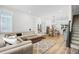 Open-concept living room with hardwood floors, a sectional sofa, and dining area at 3 Becker Nw Pl, Atlanta, GA 30307