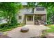 Beautifully landscaped backyard featuring a stone fire pit, patio, and green lawn, perfect for relaxing or entertaining at 3182 Windsor Lake Ne Dr, Atlanta, GA 30319