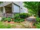 Charming backyard featuring a covered deck, mature landscaping, and a stone pathway, enhancing outdoor living at 3182 Windsor Lake Ne Dr, Atlanta, GA 30319