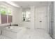 Large bathroom featuring double vanities, a soaking tub, and a glass-enclosed shower at 3182 Windsor Lake Ne Dr, Atlanta, GA 30319