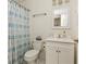 Cozy bathroom with a shower featuring a blue patterned shower curtain, white vanity and a framed mirror at 3182 Windsor Lake Ne Dr, Atlanta, GA 30319
