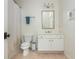 Neutral bathroom featuring a toilet, vanity with sink, mirror, towel rack and shower with a curtain at 3182 Windsor Lake Ne Dr, Atlanta, GA 30319