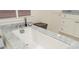 Close-up of a modern soaking tub in a bathroom with marble counters at 3182 Windsor Lake Ne Dr, Atlanta, GA 30319