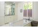 A serene bathroom with a marble countertop, soaking tub and storage at 3182 Windsor Lake Ne Dr, Atlanta, GA 30319