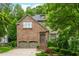 Charming stone front home featuring a well manicured yard with mature trees and an attached two car garage at 3182 Windsor Lake Ne Dr, Atlanta, GA 30319