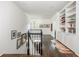 Second floor hallway featuring hardwood floors, art, and built-in bookshelves at 3182 Windsor Lake Ne Dr, Atlanta, GA 30319