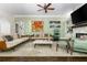 Inviting living room featuring hardwood floors, stylish sofas, a ceiling fan, and elegant decor at 3182 Windsor Lake Ne Dr, Atlanta, GA 30319