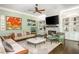 Comfortable living room featuring a fireplace, built-in shelves, sofas, and decor at 3182 Windsor Lake Ne Dr, Atlanta, GA 30319