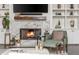 Cozy living room showcasing a fireplace, a built-in bookcase, and comfortable seating at 3182 Windsor Lake Ne Dr, Atlanta, GA 30319