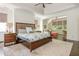 Spacious bedroom with a tray ceiling, a sitting area and a king bed, bathed in natural light at 3182 Windsor Lake Ne Dr, Atlanta, GA 30319