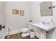 Cozy powder room with pedestal sink, wood floors, and modern fixtures at 3182 Windsor Lake Ne Dr, Atlanta, GA 30319