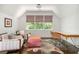 Bright, airy sitting area with hardwood floors and large windows overlooking the yard at 3182 Windsor Lake Ne Dr, Atlanta, GA 30319