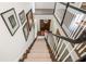 View of carpeted staircase with white banister and dark wood trim at 3182 Windsor Lake Ne Dr, Atlanta, GA 30319